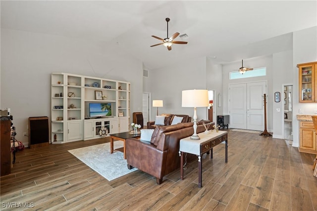 14190 Binghampton Dr, Fort Myers, FL 33905 - living area featuring high vaulted ceiling, ceiling fan, and wood finished floors