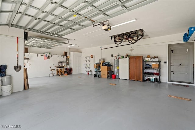 14190 Binghampton Dr, Fort Myers, FL 33905 - garage featuring freestanding refrigerator, electric water heater, and a garage door opener