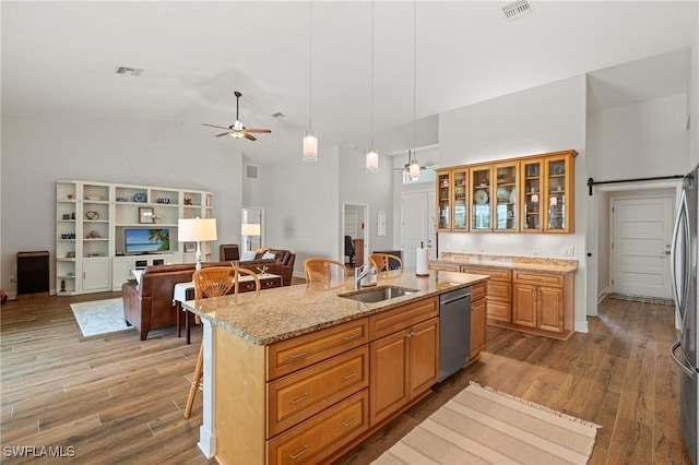 14190 Binghampton Dr, Fort Myers, FL 33905 - kitchen featuring stainless steel appliances, high vaulted ceiling, a ceiling fan, a breakfast bar area, and a center island with sink