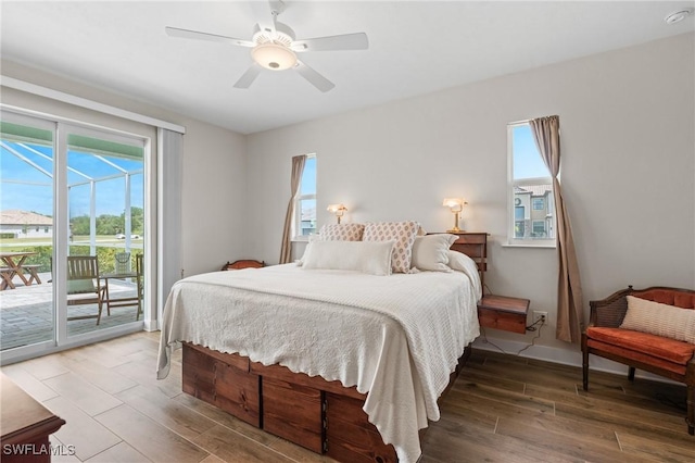 14190 Binghampton Dr, Fort Myers, FL 33905 - bedroom featuring access to outside, wood finished floors, multiple windows, and a ceiling fan