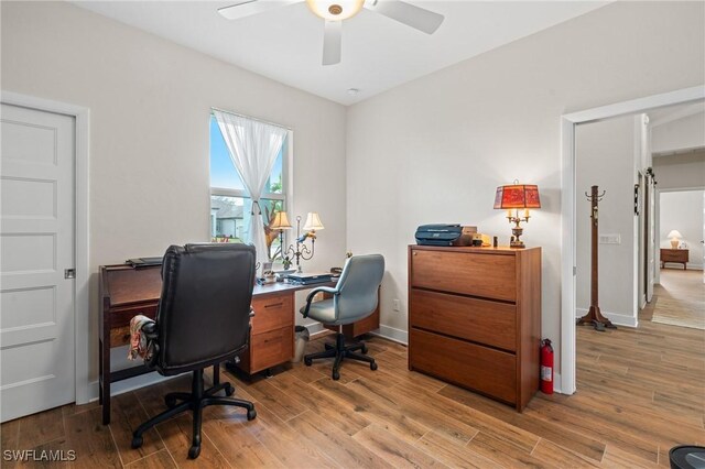 14190 Binghampton Dr, Fort Myers, FL 33905 - home office with ceiling fan and light wood-style floors