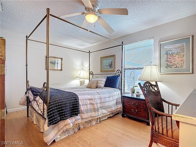432 SW 38th St, Cape Coral, FL 33914 - bedroom with light wood-style flooring, a ceiling fan, and a textured ceiling
