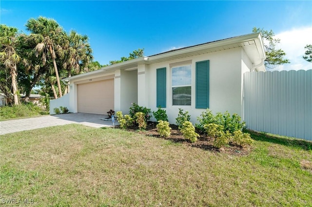 ranch-style home with a front lawn, driveway, stucco siding, and an attached garage