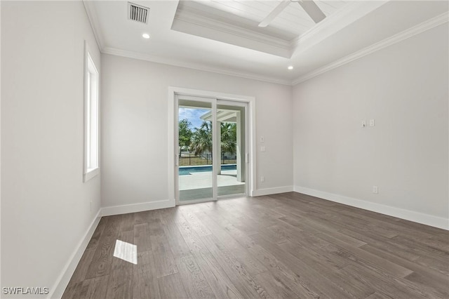 1136 Trail Terrace Dr, Naples, FL 34103 - unfurnished room featuring visible vents, crown molding, baseboards, dark wood finished floors, and a raised ceiling