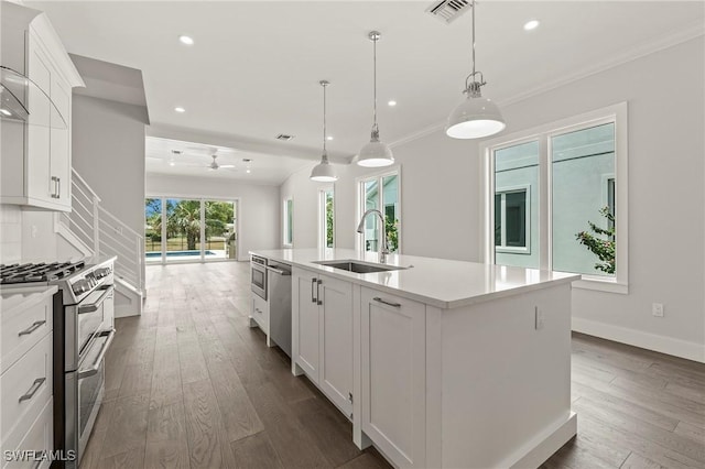 1136 Trail Terrace Dr, Naples, FL 34103 - kitchen with light countertops, visible vents, stainless steel appliances, a sink, and dark wood-style floors