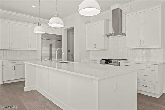 1136 Trail Terrace Dr, Naples, FL 34103 - kitchen with stainless steel appliances, ornamental molding, a sink, wall chimney range hood, and a kitchen island with sink