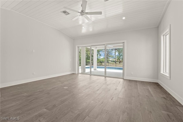 1136 Trail Terrace Dr, Naples, FL 34103 - empty room featuring baseboards, vaulted ceiling, ceiling fan, and dark wood-style flooring