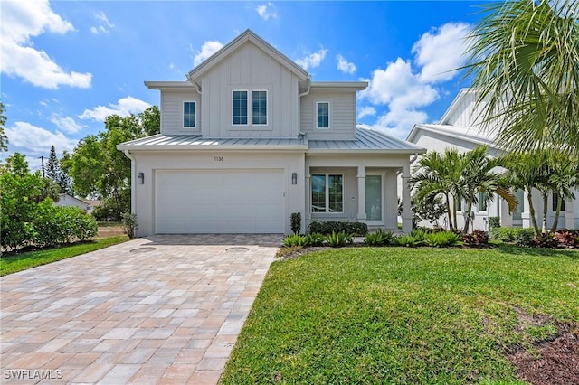 1136 Trail Terrace Dr, Naples, FL 34103 - view of front of home featuring a front lawn, decorative driveway, a standing seam roof, and metal roof