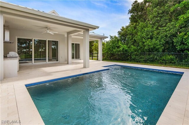 1136 Trail Terrace Dr, Naples, FL 34103 - view of pool with a patio area, exterior kitchen, fence, and ceiling fan