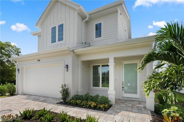 1136 Trail Terrace Dr, Naples, FL 34103 - view of front of home with decorative driveway and a garage