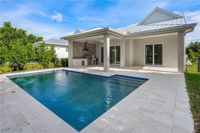 1136 Trail Terrace Dr, Naples, FL 34103 - back of property with a standing seam roof, a ceiling fan, fence, metal roof, and a patio