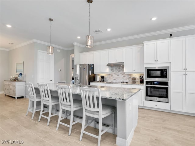 19469 The Place Blvd, Estero, FL 33928 - kitchen with black appliances, under cabinet range hood, an island with sink, ornamental molding, and white cabinetry
