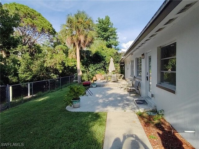 77 Cardinal Dr, North Fort Myers, FL 33917 - view of yard featuring a patio