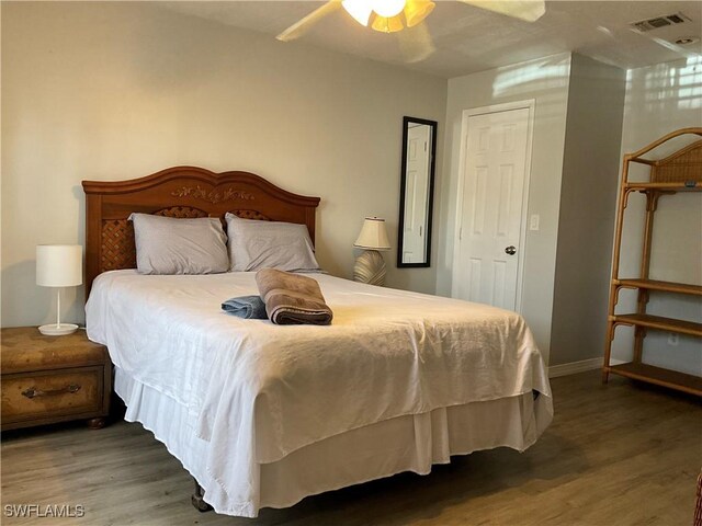 77 Cardinal Dr, North Fort Myers, FL 33917 - bedroom featuring wood finished floors, baseboards, and ceiling fan
