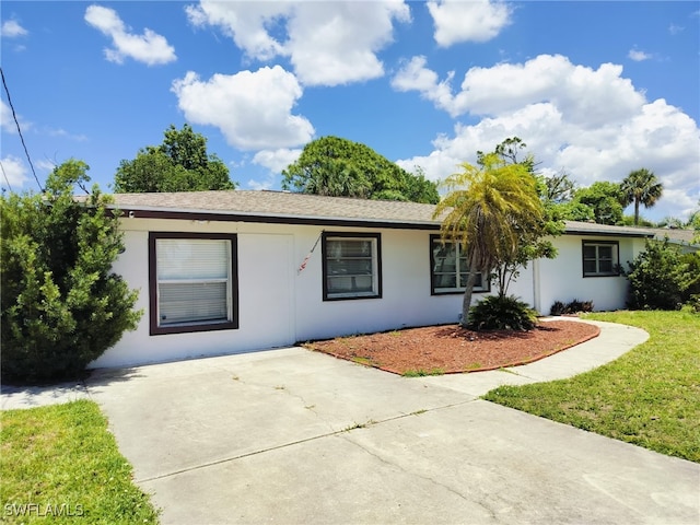 77 Cardinal Dr, North Fort Myers, FL 33917 - ranch-style house featuring stucco siding and a front yard