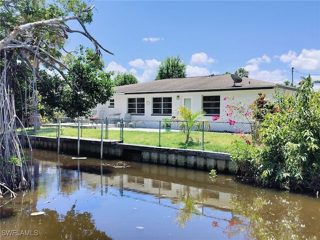 77 Cardinal Dr, North Fort Myers, FL 33917 - back of house featuring a water view and stucco siding