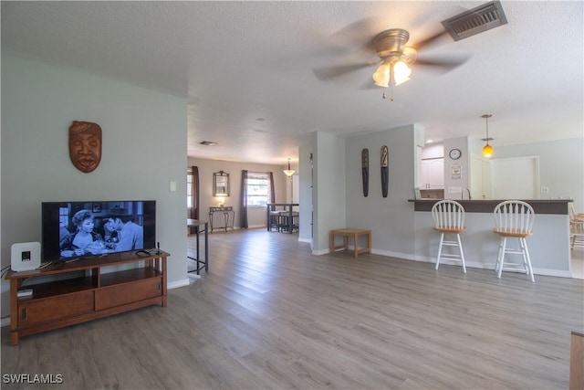 77 Cardinal Dr, North Fort Myers, FL 33917 - living room with wood finished floors, a ceiling fan, and baseboards