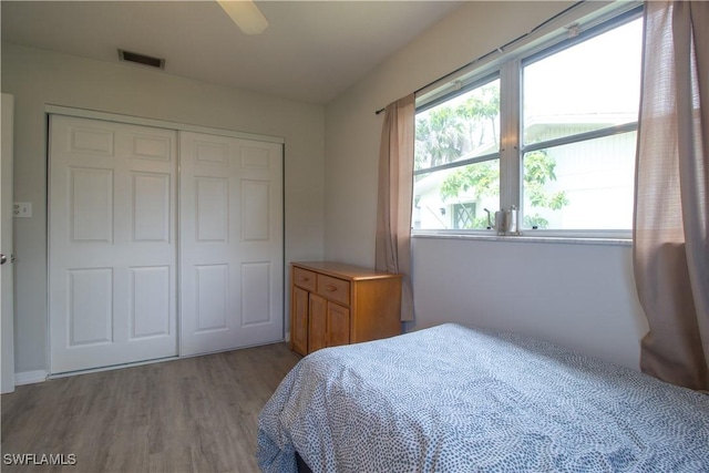 77 Cardinal Dr, North Fort Myers, FL 33917 - bedroom with wood finished floors, a closet, and ceiling fan