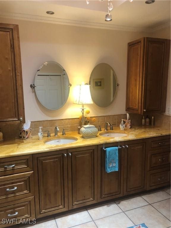 bathroom featuring tile patterned flooring, a sink, and backsplash