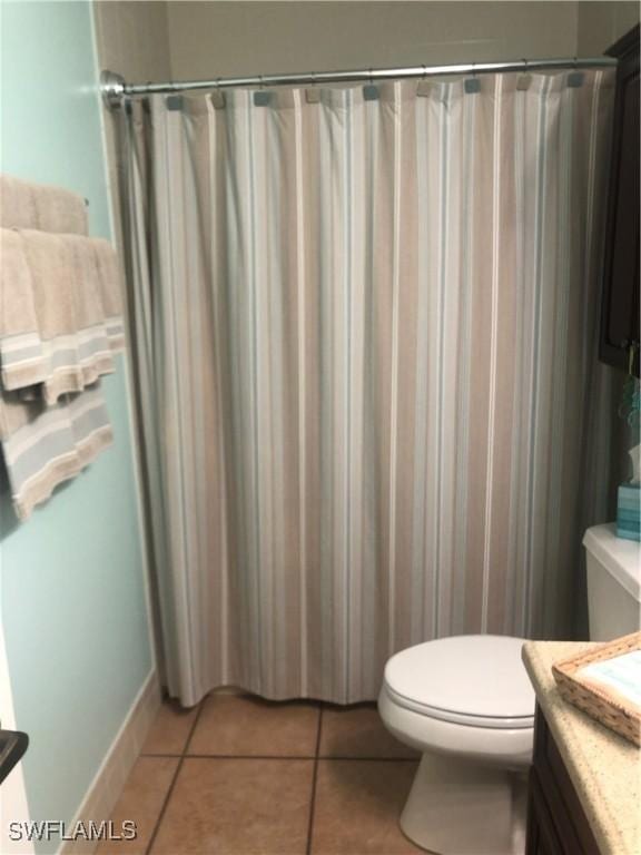 bathroom with tile patterned floors, vanity, and toilet