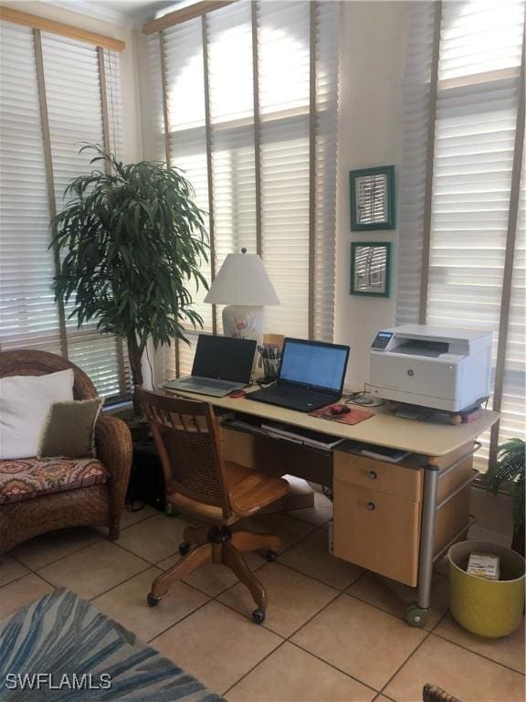 office area with plenty of natural light and light tile patterned floors