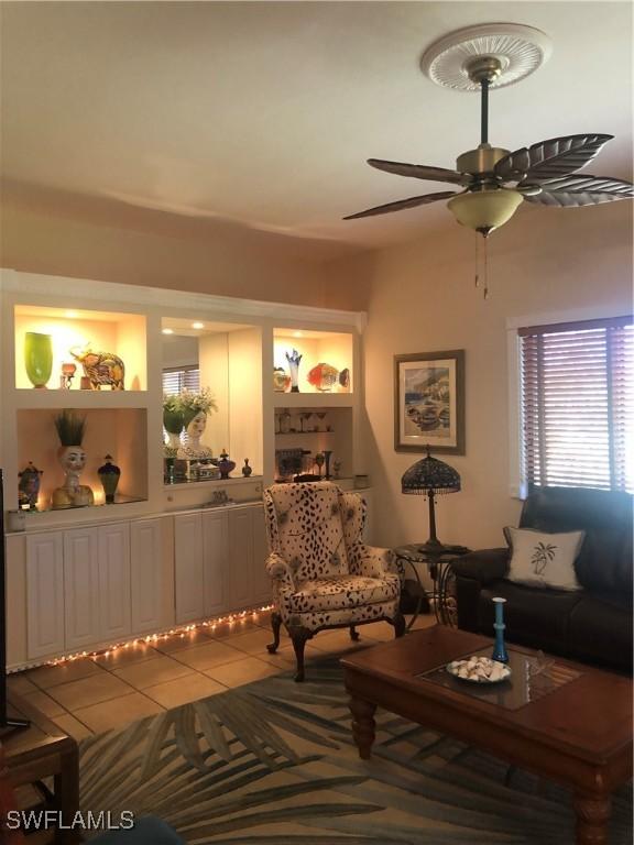 living room featuring tile patterned flooring and ceiling fan