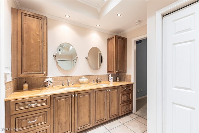 bathroom featuring recessed lighting, tasteful backsplash, ornamental molding, and a sink