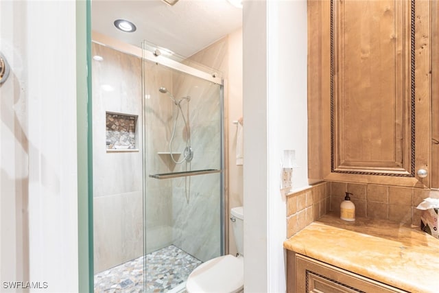full bathroom with a shower stall and toilet