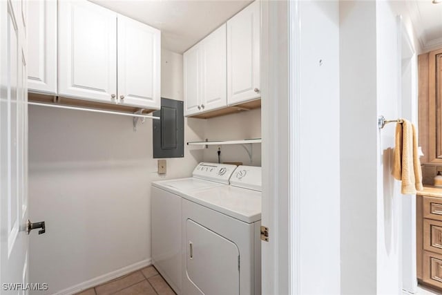 clothes washing area with separate washer and dryer, electric panel, light tile patterned floors, and cabinet space