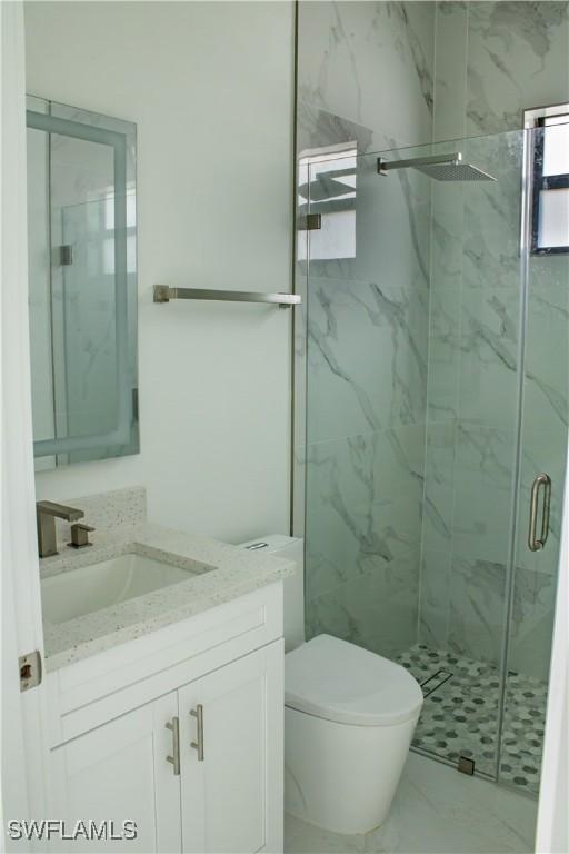 3202 72nd St W, Lehigh Acres, FL 33971 - full bath featuring vanity, a marble finish shower, and toilet