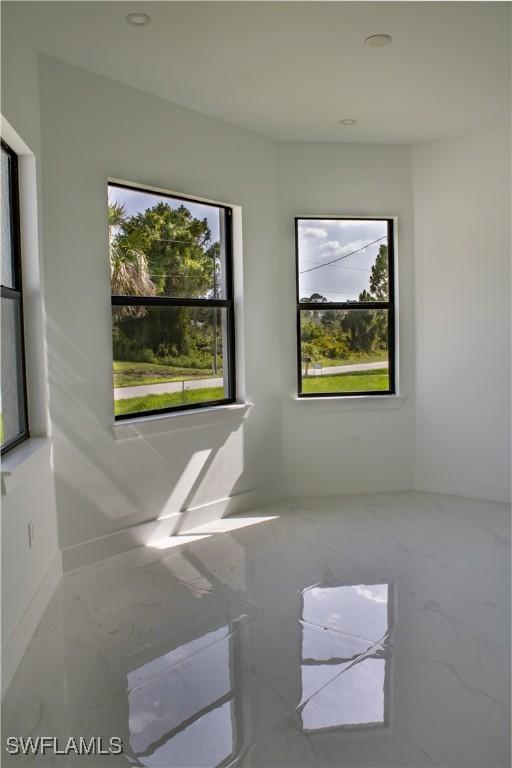 3202 72nd St W, Lehigh Acres, FL 33971 - empty room with marble finish floors