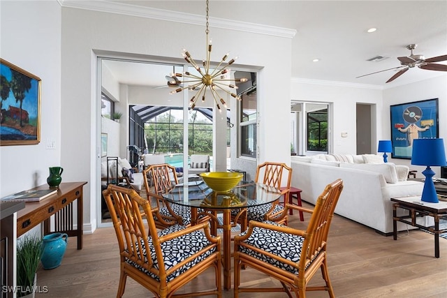 1002 Fountain Run, Naples, FL 34119 - dining room featuring a chandelier, crown molding, wood finished floors, healthy amount of natural light, and ceiling fan
