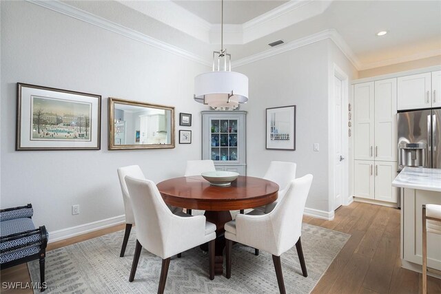 1002 Fountain Run, Naples, FL 34119 - dining room featuring hardwood / wood-style floors, crown molding, recessed lighting, a raised ceiling, and baseboards