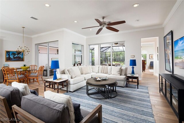 1002 Fountain Run, Naples, FL 34119 - living area featuring light wood-type flooring, recessed lighting, ceiling fan, ornamental molding, and a chandelier
