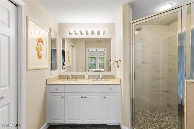 10021 Heather Ln Unit 803, Naples, FL 34119 - full bathroom with baseboards, a sink, double vanity, and a stall shower