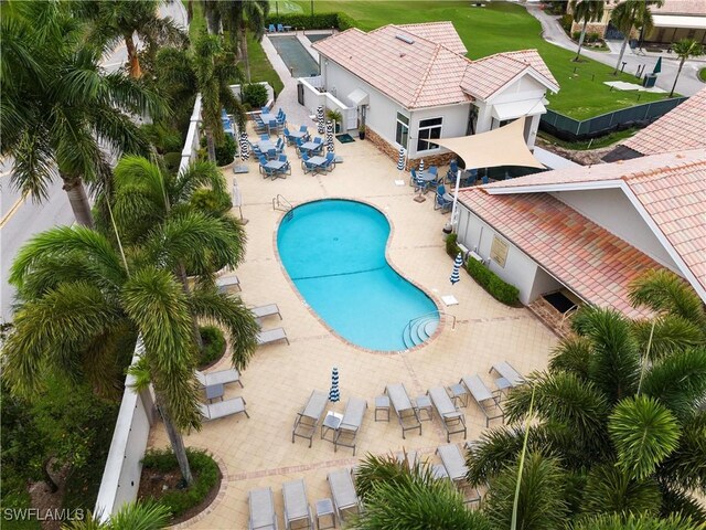 10021 Heather Ln Unit 803, Naples, FL 34119 - community pool featuring a patio and fence