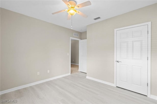unfurnished bedroom with light wood-style flooring, baseboards, and visible vents