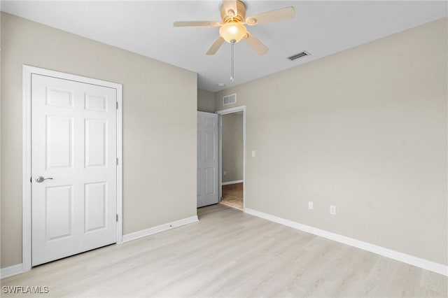 unfurnished bedroom featuring baseboards, visible vents, and light wood-style flooring