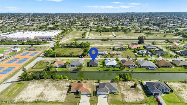 bird's eye view featuring a water view and a residential view
