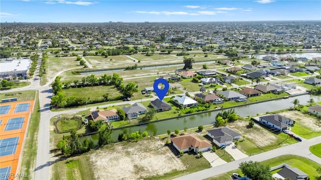 birds eye view of property with a residential view and a water view