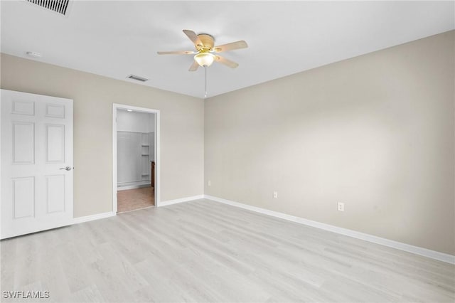 unfurnished bedroom with ceiling fan, baseboards, light wood finished floors, and visible vents