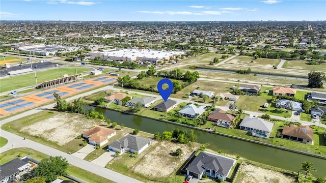 drone / aerial view with a residential view and a water view