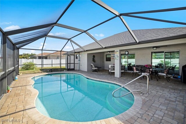 4116 SW 15th Ave, Cape Coral, FL 33914 - view of swimming pool featuring glass enclosure, a patio area, a fenced in pool, and outdoor dining area