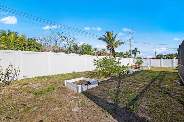 4116 SW 15th Ave, Cape Coral, FL 33914 - view of yard featuring a fenced backyard and a garden