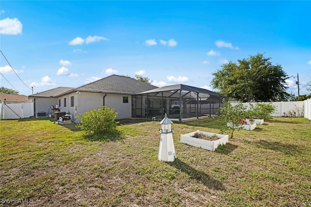 4116 SW 15th Ave, Cape Coral, FL 33914 - rear view of house featuring a fenced backyard, a lawn, and a vegetable garden
