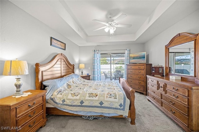 4116 SW 15th Ave, Cape Coral, FL 33914 - bedroom with ceiling fan, light carpet, access to outside, and a tray ceiling