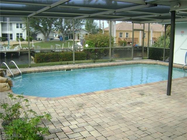 3708 SE 16th Pl, Cape Coral, FL 33904 - pool featuring glass enclosure, a patio, and a residential view