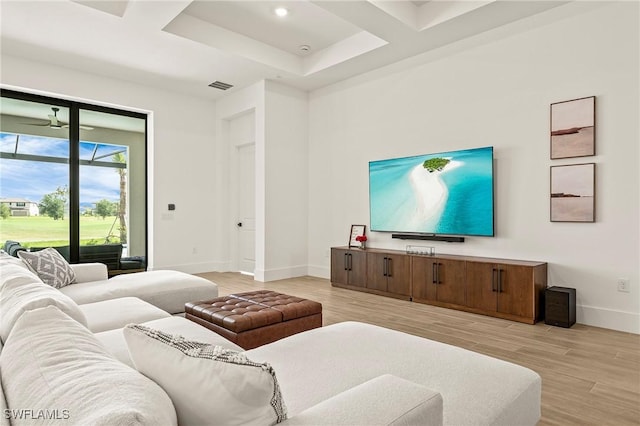 living area featuring light wood-style floors, baseboards, and visible vents