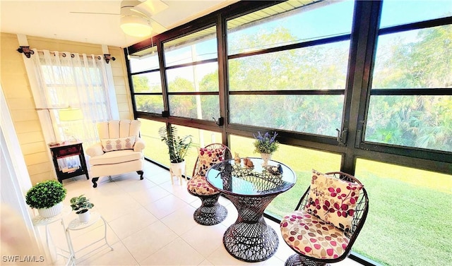 sunroom featuring tile patterned floors and ceiling fan