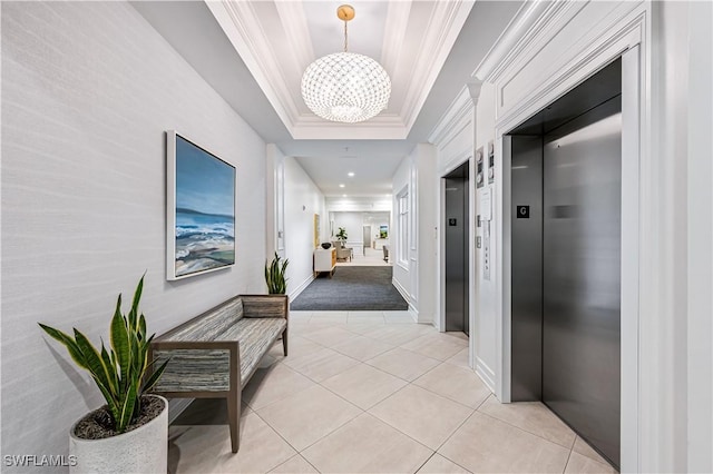 corridor featuring light tile patterned floors, ornamental molding, a chandelier, a raised ceiling, and elevator